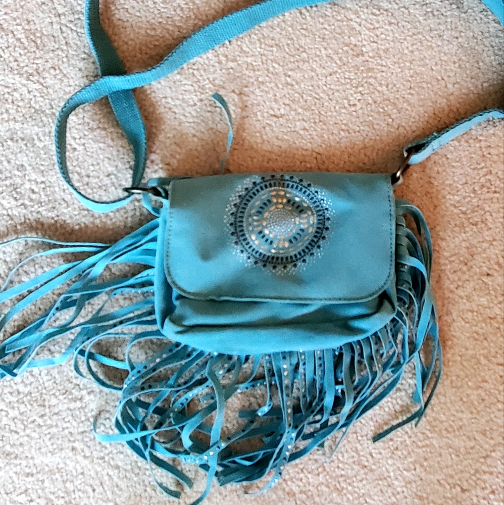 Light blue suede cross body bag with medal medallion